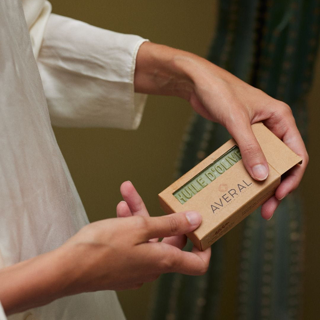 Hands holding a boxed Averal Provence Olive Oil French bar soap in a kraft box