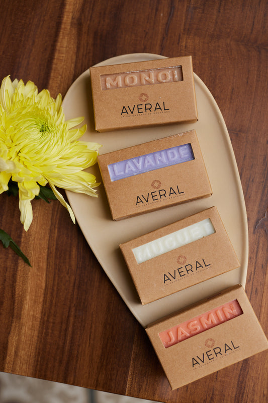 Averal Provence Floral Moisturizing Gift Set: Monoï, Lavender, Lily of the Valley and Jasmin French bar soaps on a plate with a yellow flower