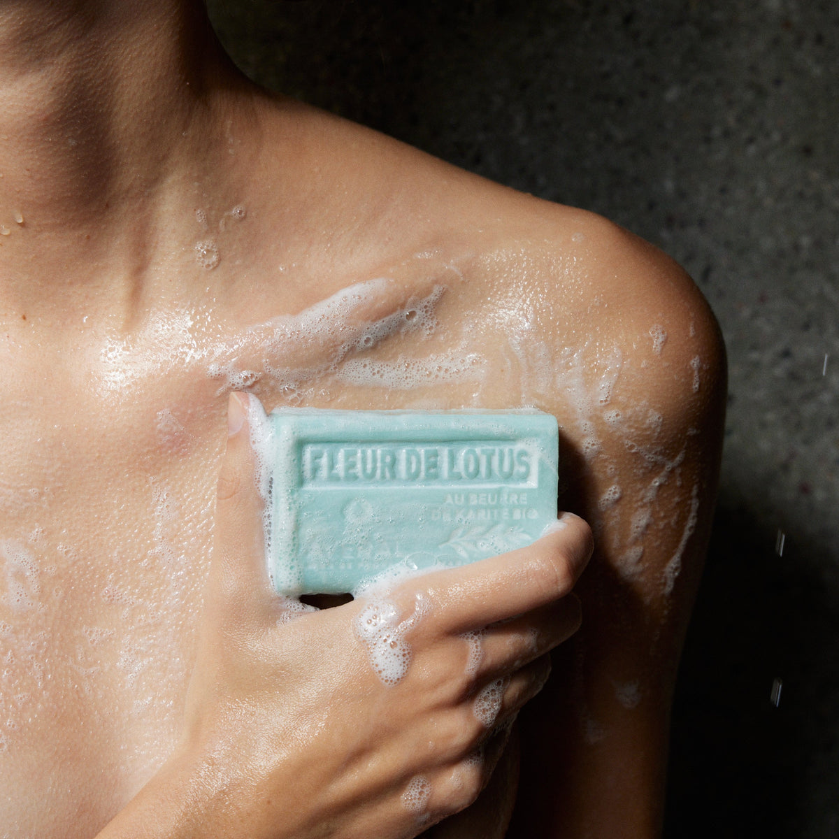 Averal Provence Lotus Flower French bar soap lathered on the shoulder