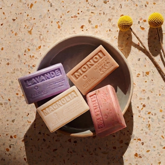 Averal Provence Lavender, Monoi, Magnolia and Rose Petals French bar soaps in a ceramic bowl on terrazzo